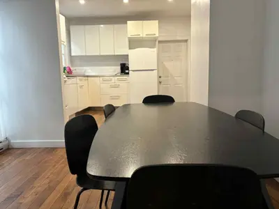 a dining room table with chairs and a kitchen at Spacious apartment in dowtown Montreal in Montréal
