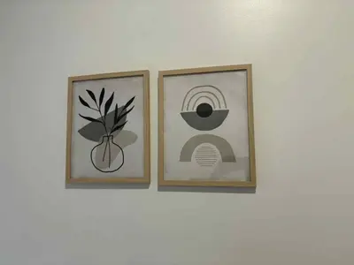 two framed pictures on a white wall at Spacious apartment in dowtown Montreal in Montréal