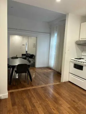 a kitchen and living room with a table and a stove at Spacious apartment in dowtown Montreal in Montréal