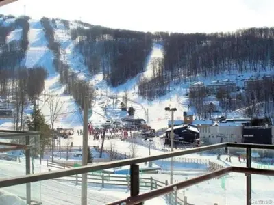 a view of a ski slope with a ski resort at Superbe ski-in ski-out condo in Bromont