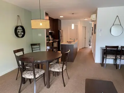 a kitchen and dining room with a table and chairs at Superbe ski-in ski-out condo in Bromont