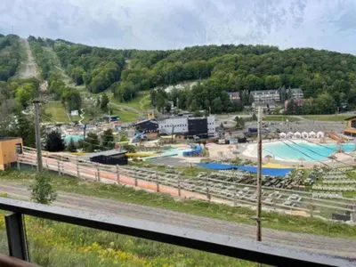 a view of a water park on a hill at Superbe ski-in ski-out condo in Bromont