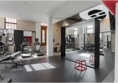 a gym with treadmills and machines in a room at TDC2 - 28th floor - 2 bd, 2 bth in Montréal