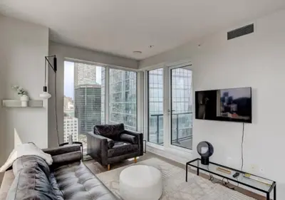 a living room with a couch and a chair at TDC2 - 28th floor - 2 bd, 2 bth in Montréal