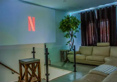 a living room with a couch and a table at Modern Apartment - Home Theater and Premium Kitchen in Terrebonne
