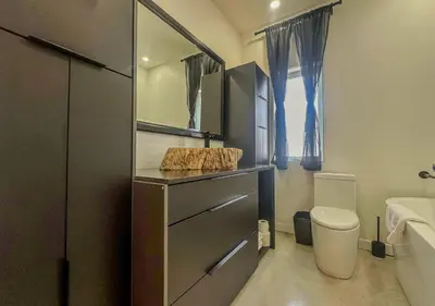 a bathroom with a sink and a toilet and a mirror at Modern Apartment - Home Theater and Premium Kitchen in Terrebonne
