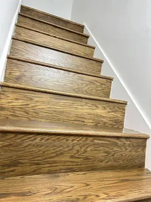a wooden staircase with wood treads in a house at Downtown 2B Basement Unit in Montréal