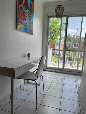 a desk and chair in a room with a window at Large Sunny 3 bedroom home in great neighbourhood in Montréal