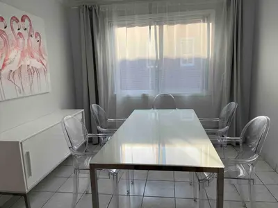 a dining room with a table and chairs and a window at Large Sunny 3 bedroom home in great neighbourhood in Montréal