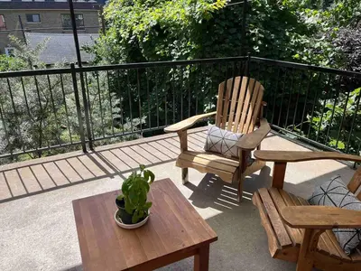 a patio with two chairs and a table and a potted plant at Large Sunny 3 bedroom home in great neighbourhood in Montréal