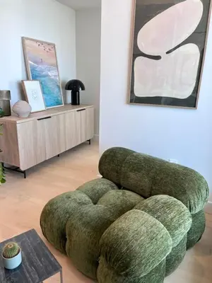 a living room with a green chair and a table at Luxurious condo dowtown Montréal in Montréal
