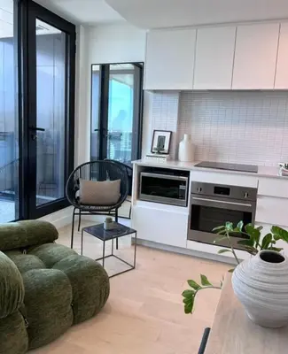 a living room with a couch and a kitchen at Luxurious condo dowtown Montréal in Montréal