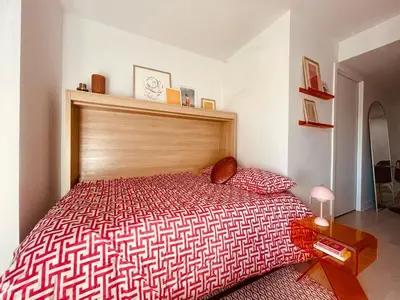 a bedroom with a red bed with a wooden headboard at Studio in Griffintown in Montréal
