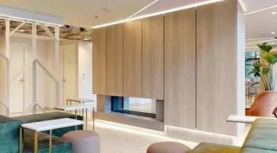 a living room with a fireplace and wooden cabinets at Studio in Griffintown in Montréal