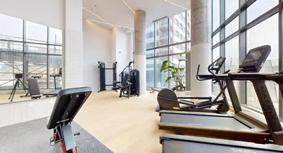 a gym with cardio equipment in a large room with windows at Studio in Griffintown in Montréal
