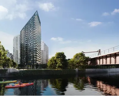 a rendering of a tall building next to a river at Studio in Griffintown in Montréal
