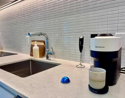 a kitchen counter with a coffee maker and a mixer at Luxurious studio downtown Montreal in Montréal