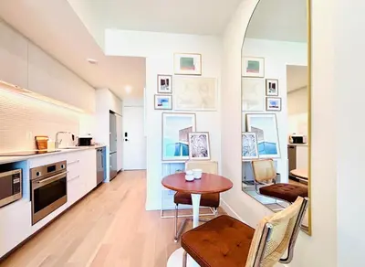 a kitchen and dining room with a table and chairs at Luxurious studio downtown Montreal in Montréal