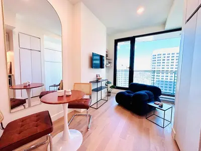 a living room with a table and a couch at Luxurious studio downtown Montreal in Montréal