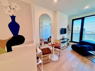 a living room with a vase painting on the wall at Luxurious studio downtown Montreal in Montréal