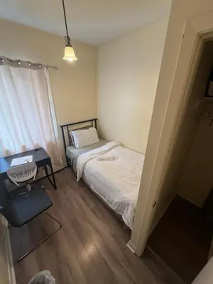 a small bedroom with a bed and a desk at Private Room Not Entire Apt Steps DownTown 18Mins Airport in Montréal