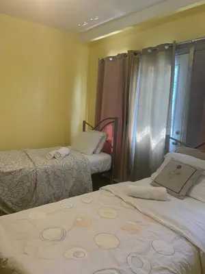 a hotel room with two beds and a window at Private Room Not Entire Apt Steps DownTown 18Mins Airport in Montréal