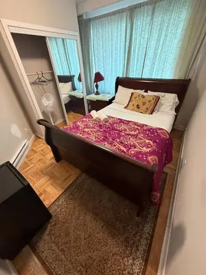 a bedroom with a large bed and a large window at Private Room Not Entire Apt Steps DownTown 18Mins Airport in Montréal