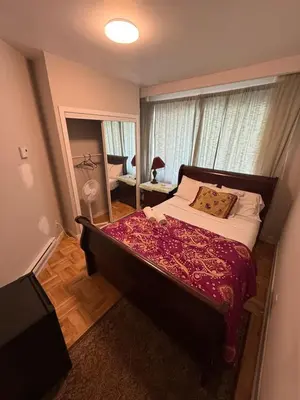 a bedroom with a large bed and a window at Private Room Not Entire Apt Steps DownTown 18Mins Airport in Montréal