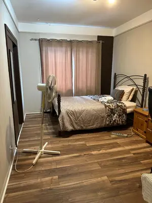 a bedroom with a bed and a fan on the floor at Private Room Not Entire Apt Steps DownTown 18Mins Airport in Montréal