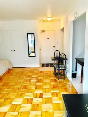 a living room with a wooden floor and a table at Modern Apartment City Living in the Golden Square Mile in Montréal