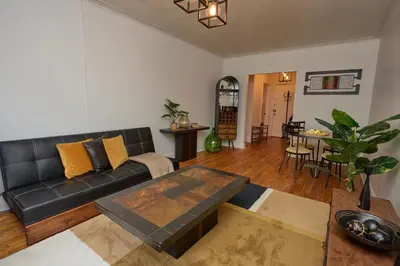a living room with a black couch and a table at Van Horne Black VIP in Montréal