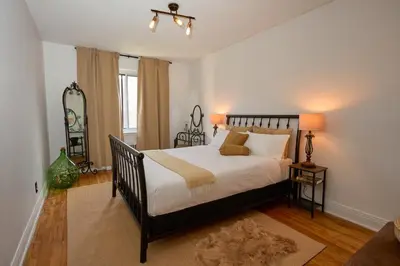 a bedroom with a large bed and a window at Van Horne Black VIP in Montréal
