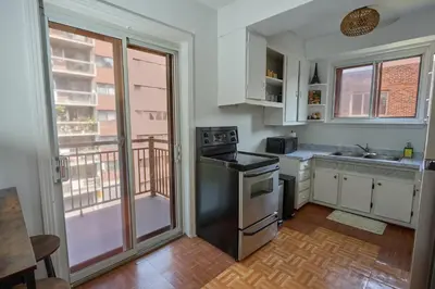 a kitchen with stainless steel appliances and a balcony at Van Horne Black VIP in Montréal