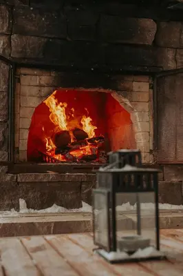 a brick oven with a fire in it at Spa Scandinave - Les Balancoires in Mansonville