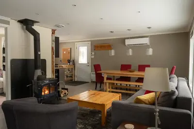 a living room with a couch and a wood stove at Spa Scandinave - Les Balancoires in Mansonville
