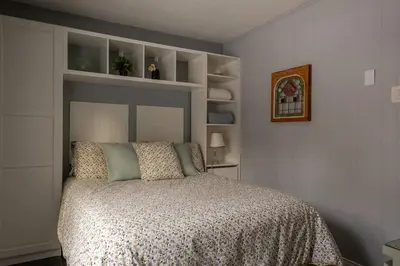 a bedroom with a bed with a gray headboard at Spa Scandinave - Les Balancoires in Mansonville