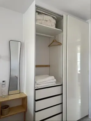 a white closet with a mirror and white towels at Cozy 1 bdrm apartment in the Village in Montréal