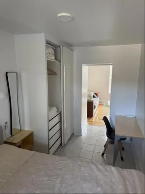 a bedroom with a bed and a desk and a chair at Cozy 1 bdrm apartment in the Village in Montréal