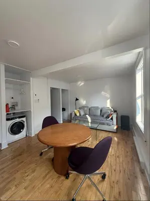 a living room with a table and chairs and a bed at Cozy 1 bdrm apartment in the Village in Montréal