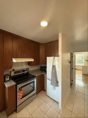 a kitchen with a stove and a refrigerator at Cozy 1 bdrm apartment in the Village in Montréal