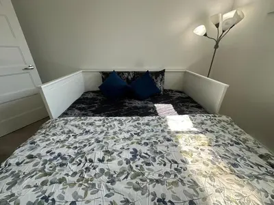 a bedroom with a bed with blue pillows at Baraqah Residence Gorgeous New 5BD Home 15mins-MTL in Longueuil