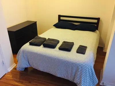a bedroom with a bed with two pillows on it at Modern City Studio Living in the Golden Square Mile in Montréal