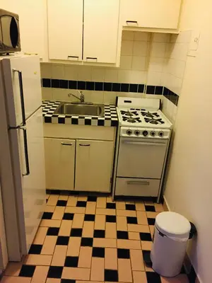 a kitchen with a sink and a stove at Modern City Studio Living in the Golden Square Mile in Montréal