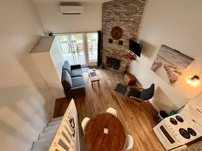 an overhead view of a living room with a fireplace at Lumineux condo au bord du lac in Magog-Orford