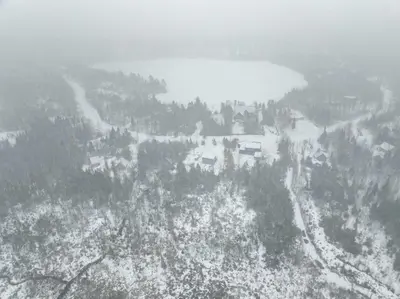 an aerial view of a snow covered mountain with a lake at Nature Spa & Lake Access - Le Maikel in Beauceville-Est
