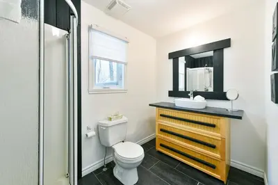 a bathroom with a toilet and a sink and a shower at Studio à Val-Racine - Ciel étoilé, Mont-Mégantic in Notre-Dame-Des-Bois
