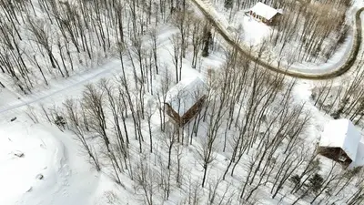 an aerial view of a snow covered road and trees at Studio à Val-Racine - Ciel étoilé, Mont-Mégantic in Notre-Dame-Des-Bois