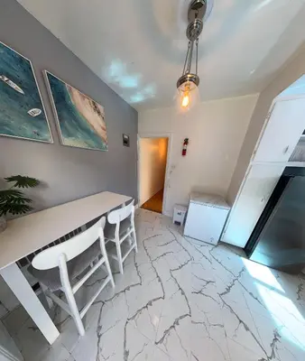 a room with a white table and chairs and a staircase at Van Horne Sweet Celebration in Montréal