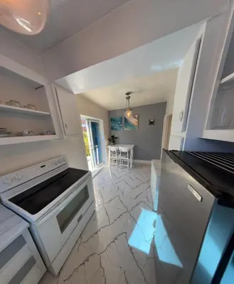a kitchen with a stove and a counter top at Van Horne Sweet Celebration in Montréal
