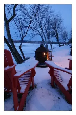a winter scene with a lantern in the snow at Lakefront Spa - Chez Bernard L'Hermite in St-Ferdinand